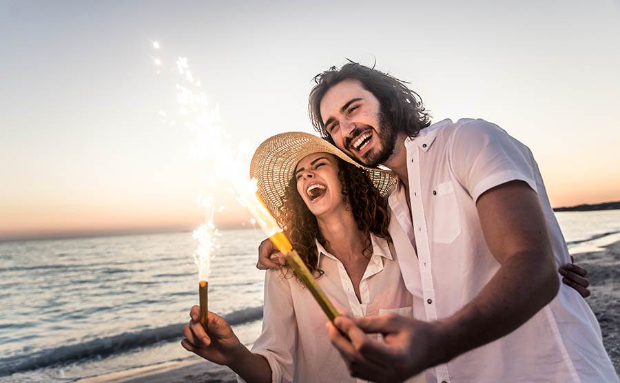 couple on the beach with sparklers