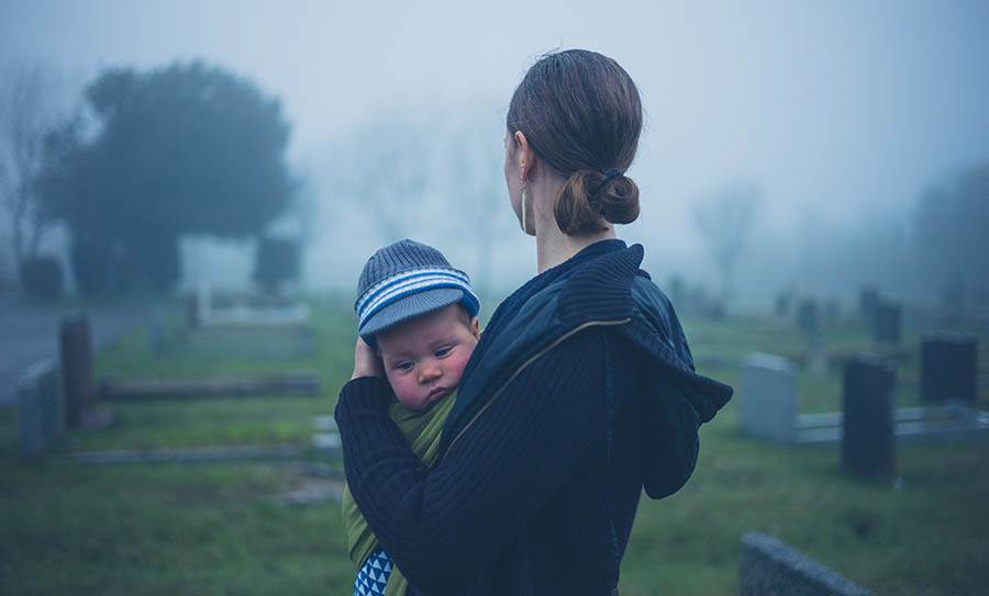A grieving young widow and child