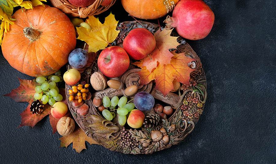 bowl with fall harvest of fruits and vegetables