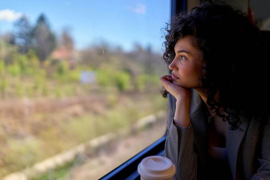 Woman looking wistfully out a window